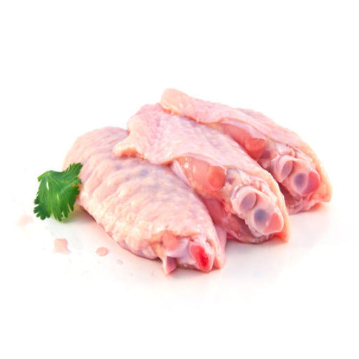 Raw chicken wings with a sprig of parsley on a white background