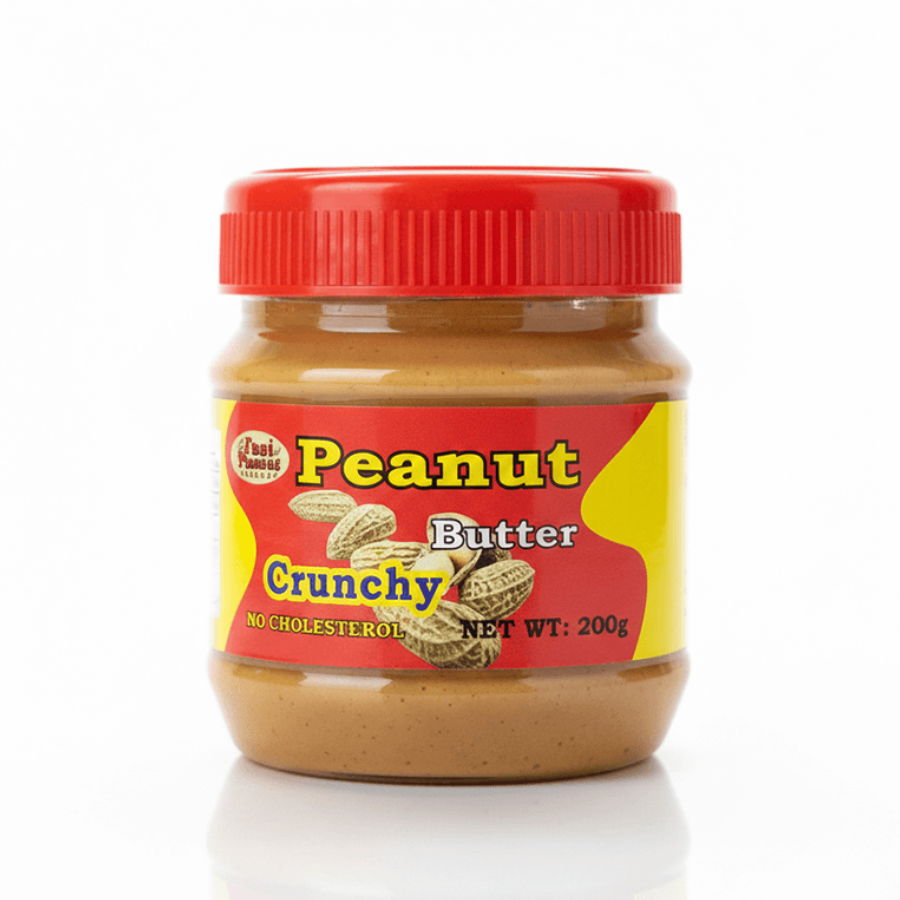 Jar of crunchy peanut butter with a red lid on a white background